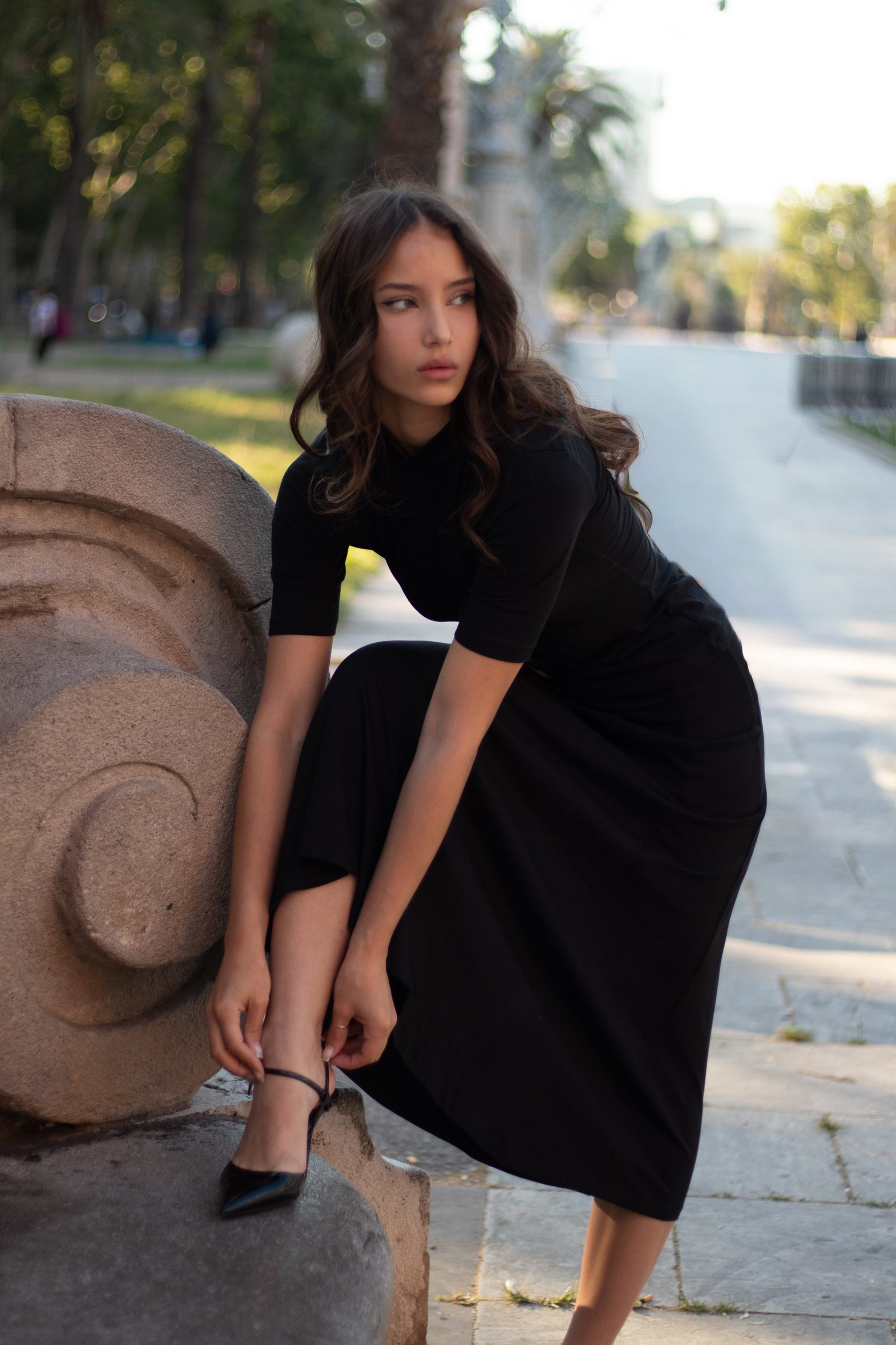 Portrait seated in a black dress