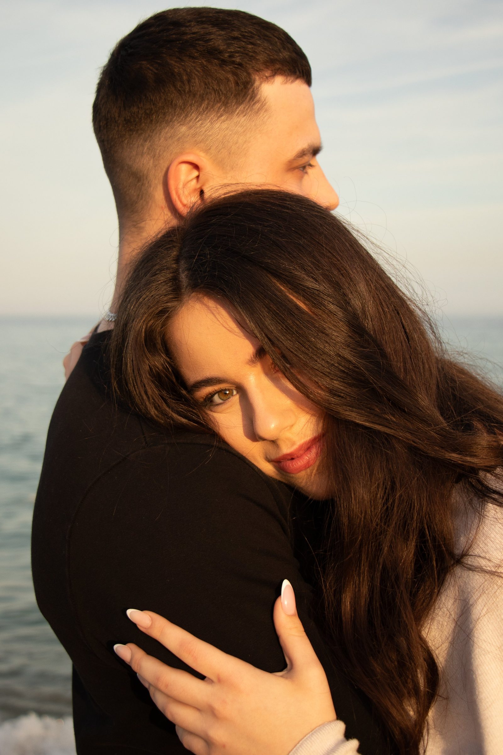 Couple by the sea at golden hour