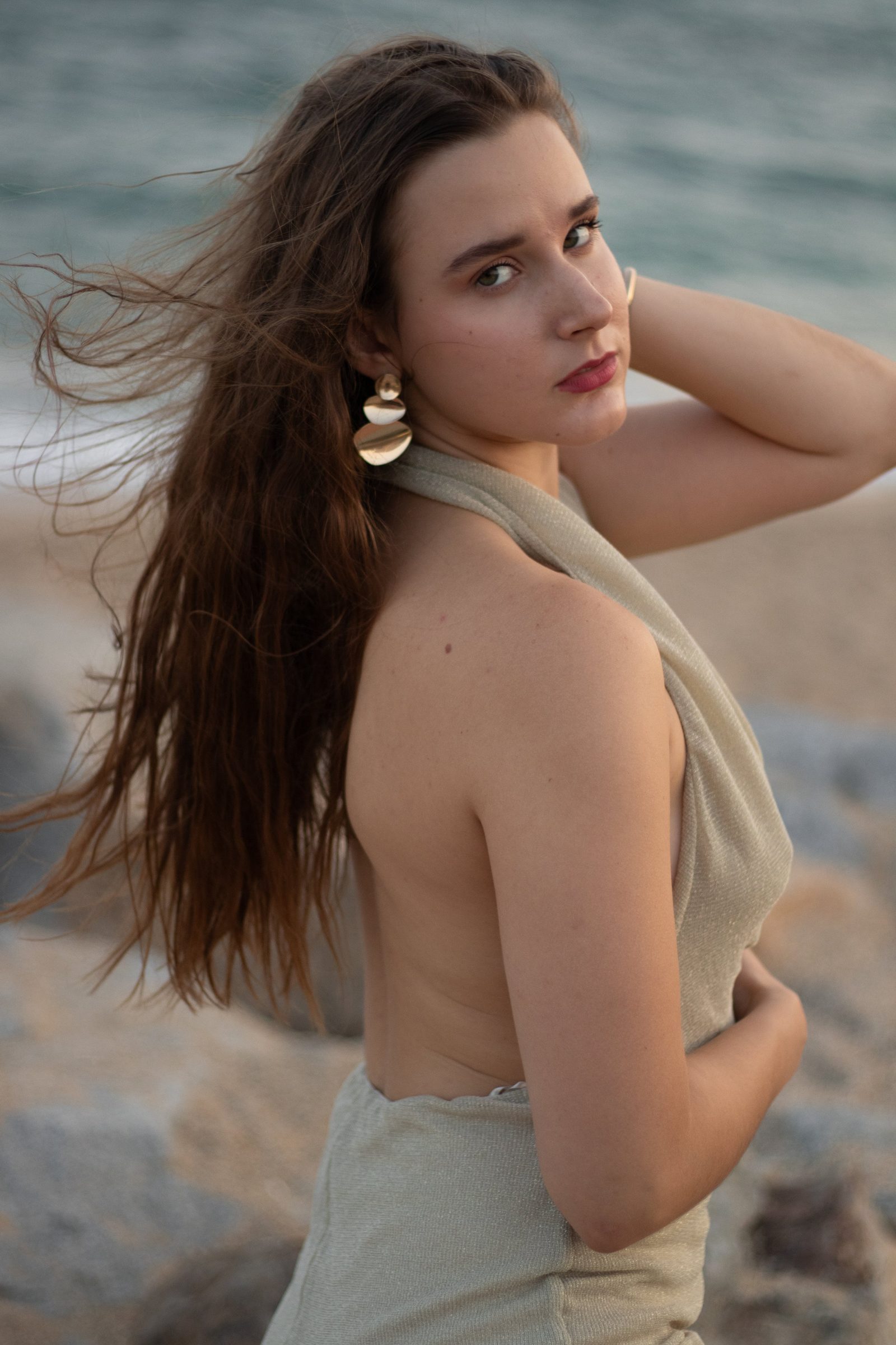 Portrait in a gold dress by the sea