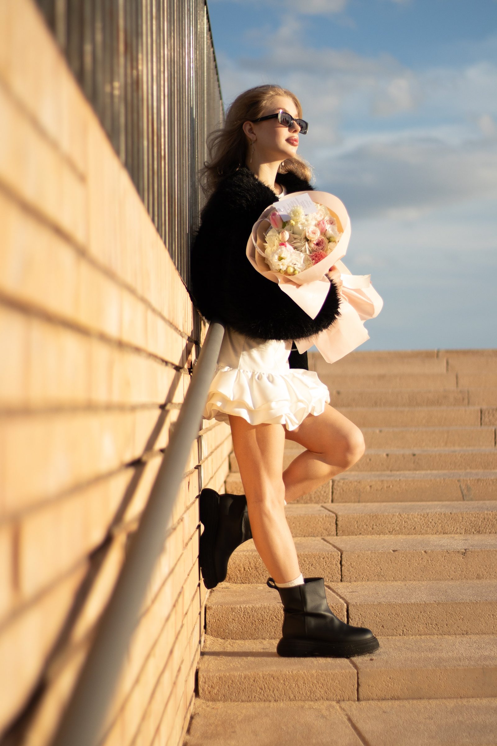 Portrait with flowers against a wall